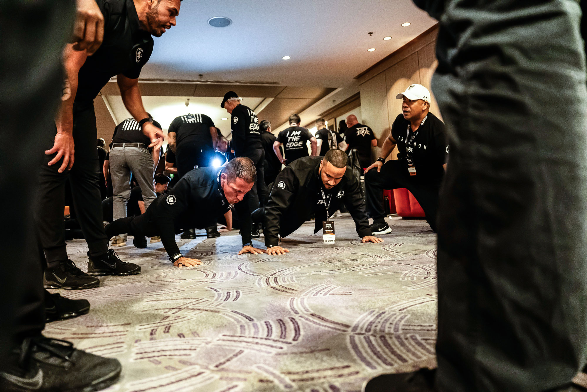 EDGE leadership summit participants pushing through a physical exercise during a leadership training experience.